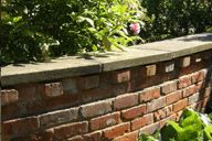 Repaired brick wall with reclaimed bricks